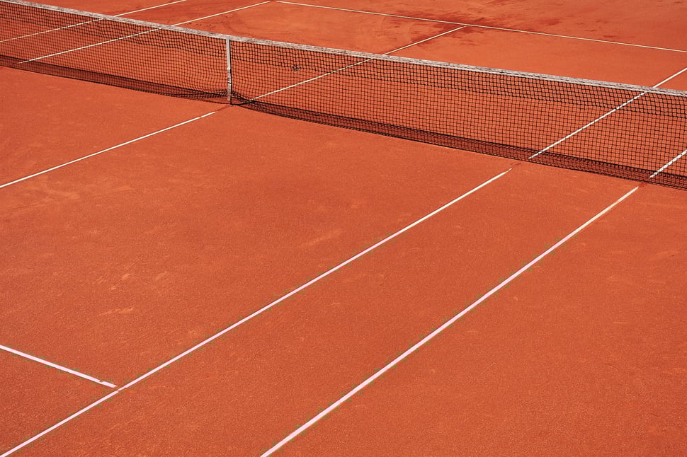 The image shows a bird's eye view of a clay tennis court.
