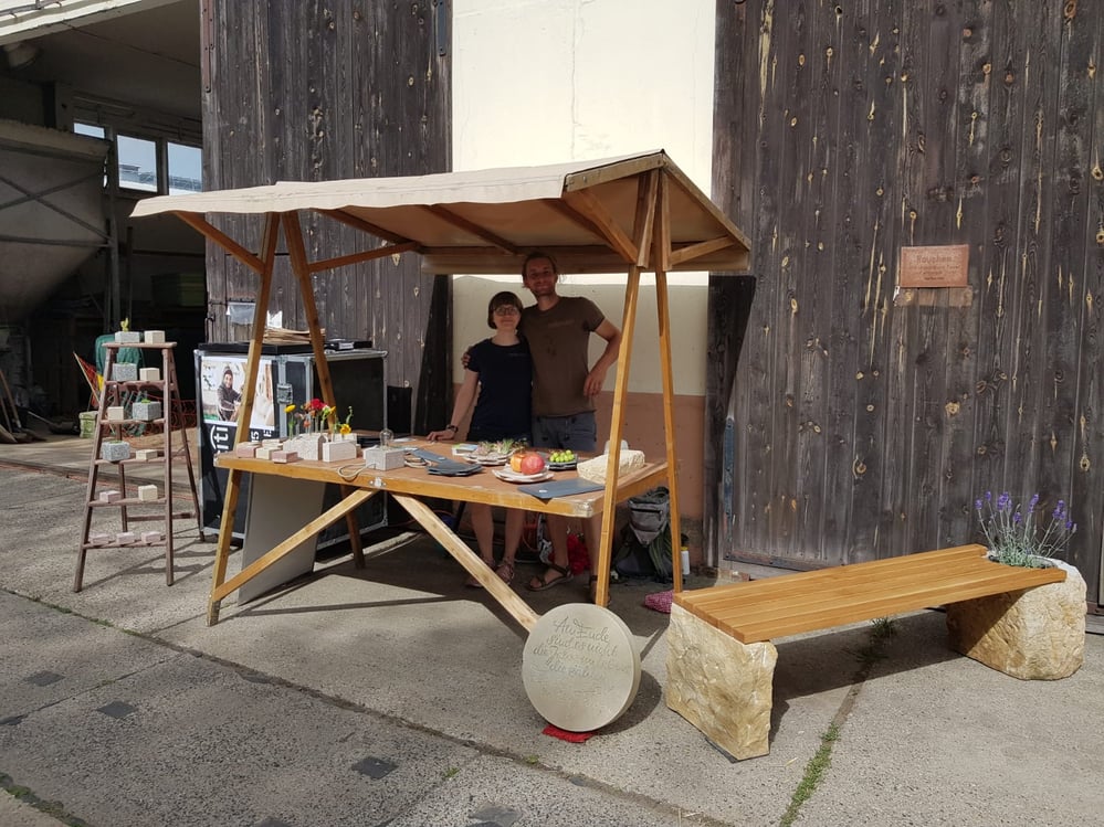 Anne Fischer und Marcus Scheffczyk von Meilenstein stehen an ihrem Stand bei einem Naturmarkt